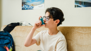 Teen using an inhaler for their asthma