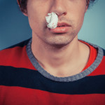 Man with nose bleed and cold sores