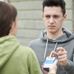 Girl Offering Teenage Boy Cigarette Outdoors