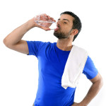 young attractive and athletic sport man drinking water