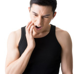 Young Asian man with toothache