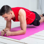 fitness training athletic sporty man doing plank exercise in gym or home concept exercising workout aerobic