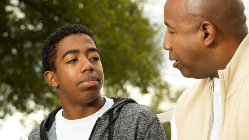 Father and son in deep conversation.